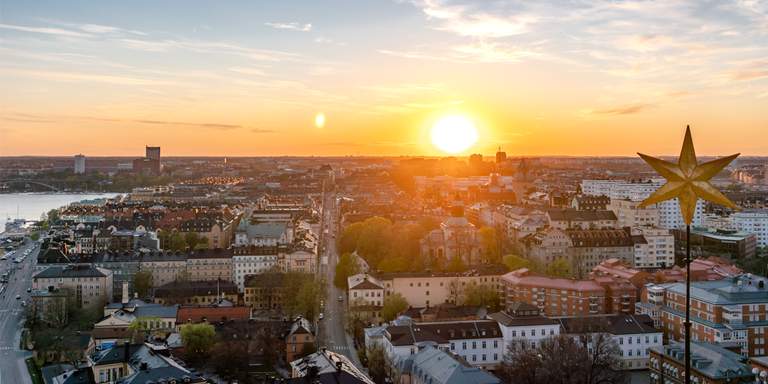 The sun is going down over Kungsholmen in Stockholm, view from the City Hall Tower in April.