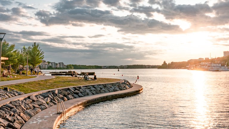 Summer in Stockholm. Summer at Hornsbergs strand. People are sitting at the waterfront, enjoying a summer evening.