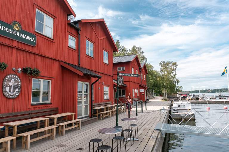 Red painter wooden houses along a quay on a sunny summer day