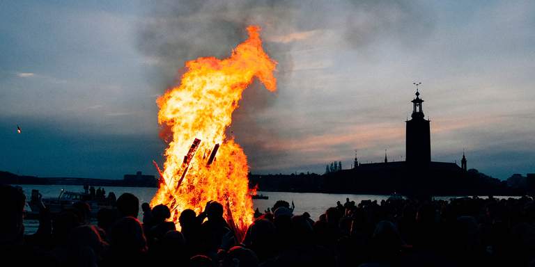A traditional Walpurgis bonfire on Riddarholmen in Stockholm. The Stockholm City Hall is visible in the background. Walpurgis, or Valborgsmässoafton, is a Swedish tradition that dates back to the Middle Ages. It's celebrated the 30th of April each year.