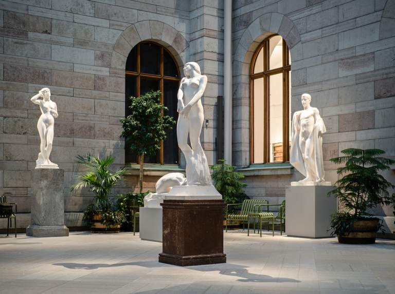 White marble sculptures in an open, bright space