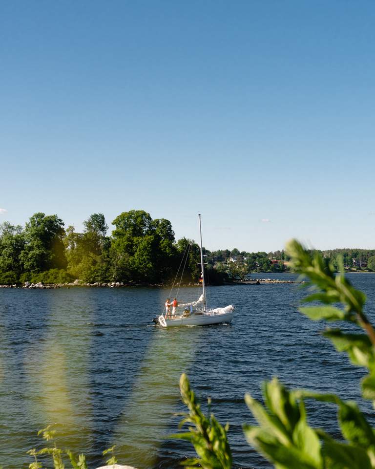 The Stockholm archipelago. A sailboat is travelling in the waters near Fjäderholmarna.