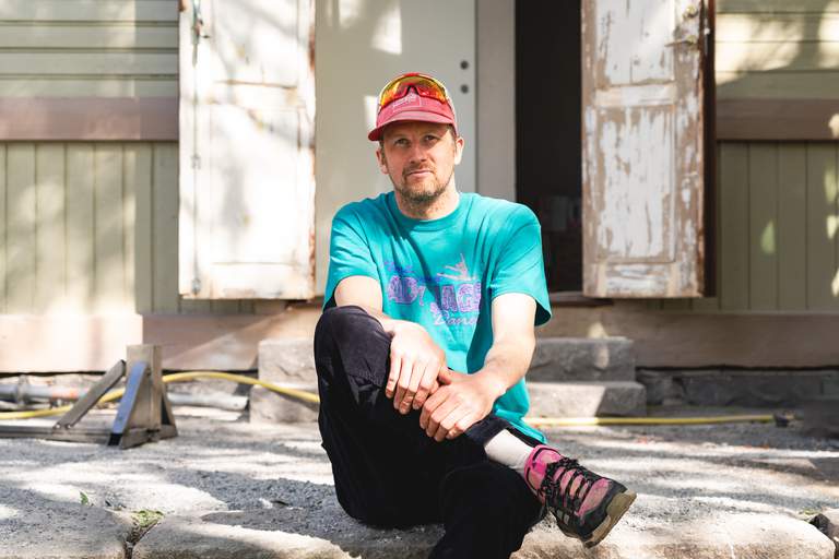 Jakob Grandin, entrepreneur in Stockholm's night club scene sitting on the steps in front of Eden.