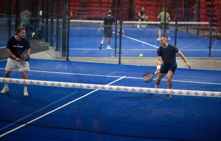 Two men play padel at the Ericsson Globe arena in Stockholm