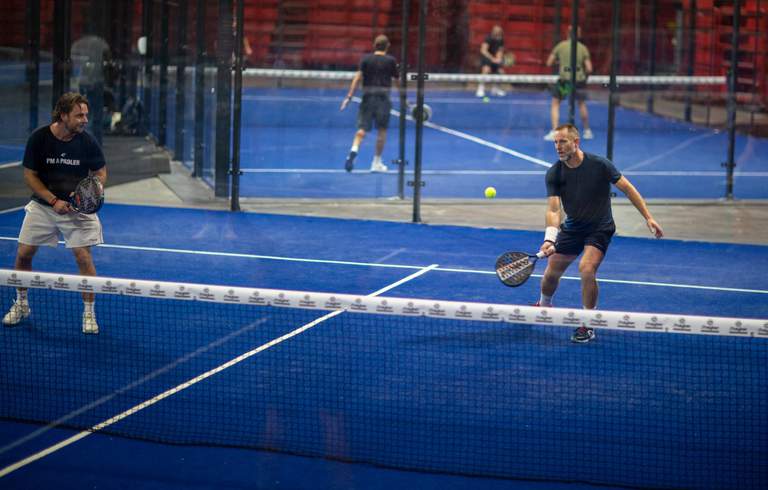 Two men play padel at the Ericsson Globe arena in Stockholm