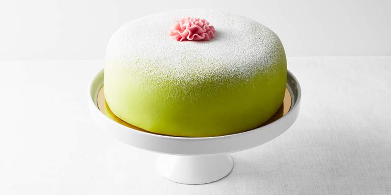 Swedish fika. A traditional princess cake, covered in a green marzipan coat. The princess cake is one of the most beloved deserts in Sweden.