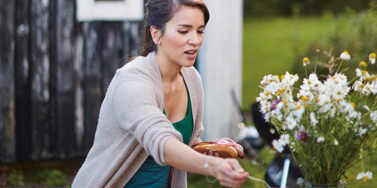 Chef and author Rachel Khoo preparing a meal outdoors. The photo is from her book about Swedish cooking, 'The Little Swedish Kitchen'.