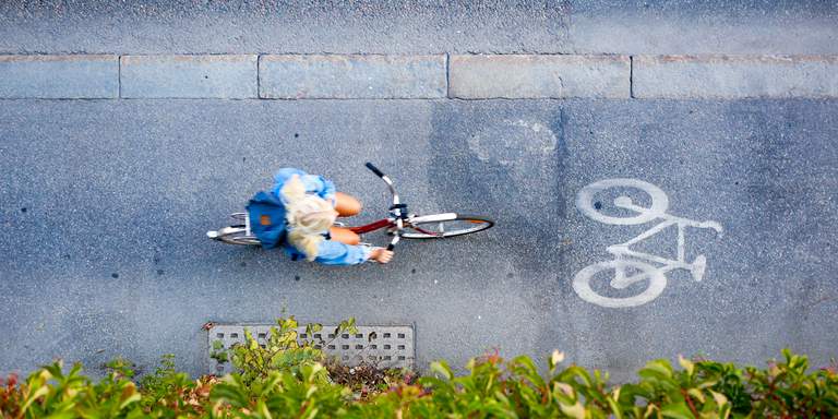 Cycling in Stockholm. A birdsview shot of woman riding a bike on Hornsgatan in Stockholm on a sunny day.