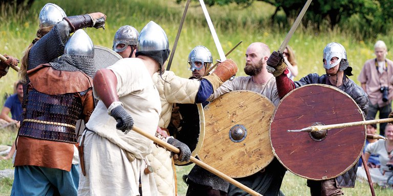 Vikings in Sweden. Actors play out a viking-battle, dressed in armor, helmets and chainmail. There are several viking-attractions in and around Stockholm for history buffs to visit.