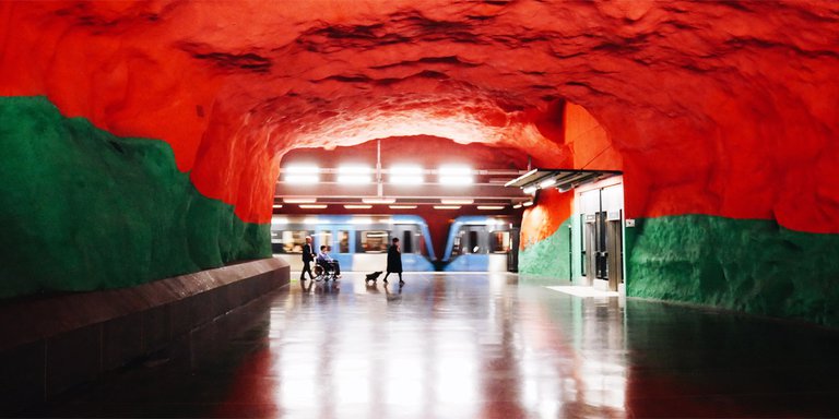 Solna centrum subway station in Stockholm. The station’s walls are painted green, reminiscent of a forest, and the ceiling is red like a summer’s sunset.