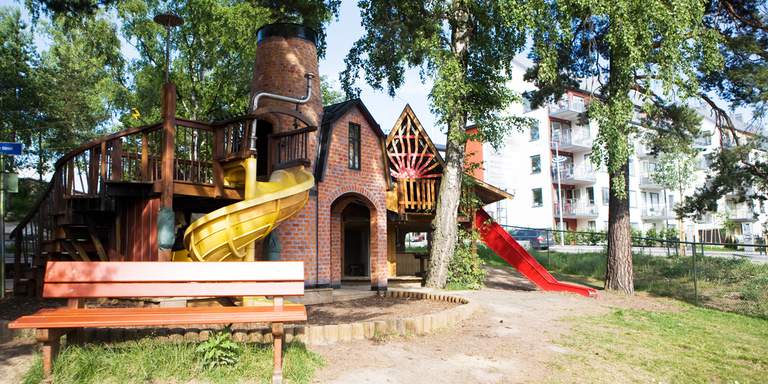 A large statue of Gary Gadget the mechanic and his dog Buffa. They are welcoming children to their playground in Solna, outside the city centre. The park is a wonderful space for small children to play.