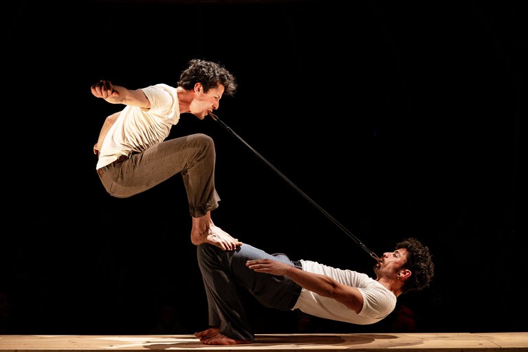 Circus artists on a stage.