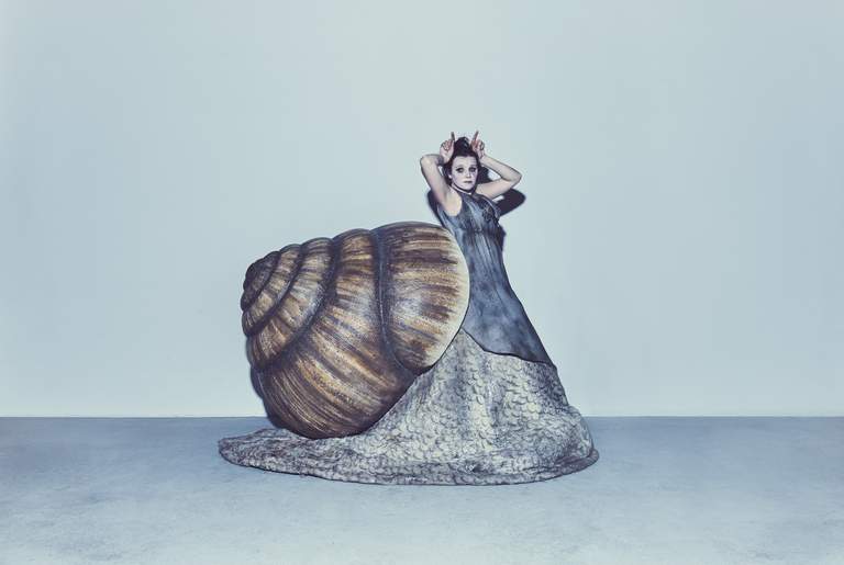 An actress in a snail costume.