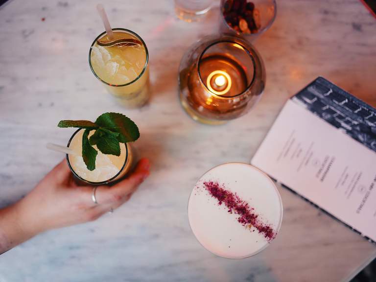 Bars in Stockholm. A hand is reaching for a glas at Berns.