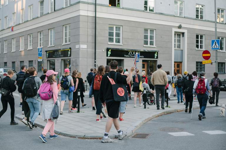 Many people walking on a city street.