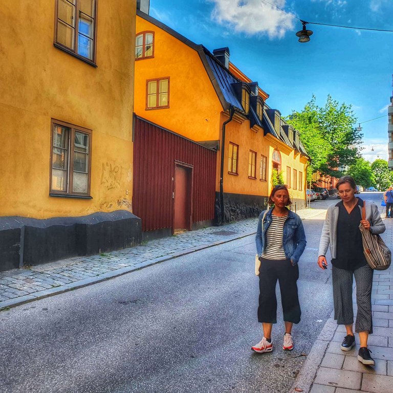 two people walking along a street