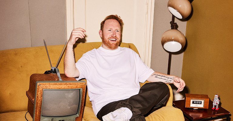 Gavin James sitting on a couch.