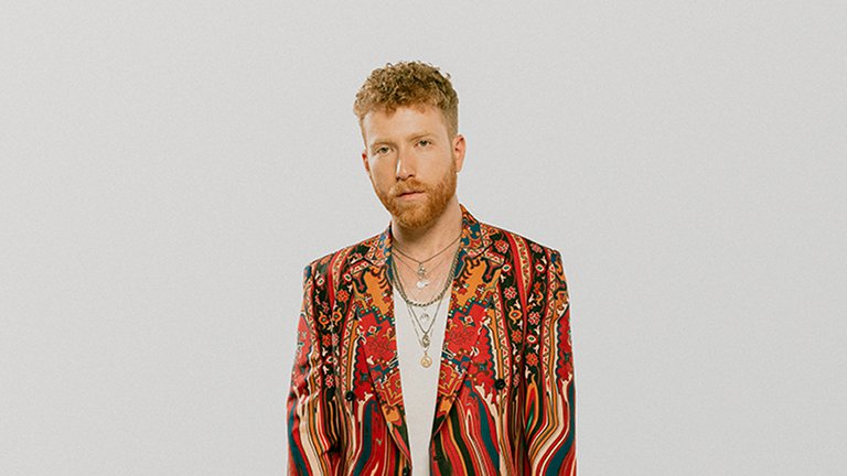 A man in a colorful blazer.