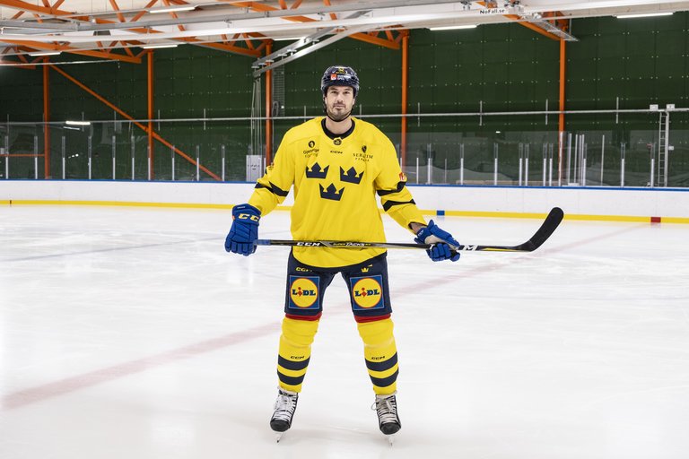 Jonathan Ericsson on the ice wearing full hockey gear and a national team jersey.
