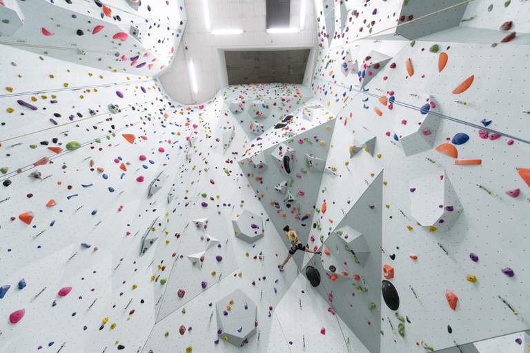 Activities in Stockholm. A woman climbs up the walls at Klätterverket.