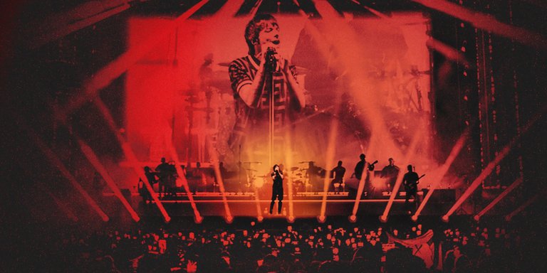 The artist Louis Tomlinson performing on a stage.