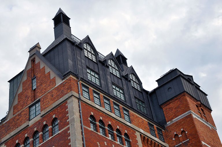 Brick building with a black roof.