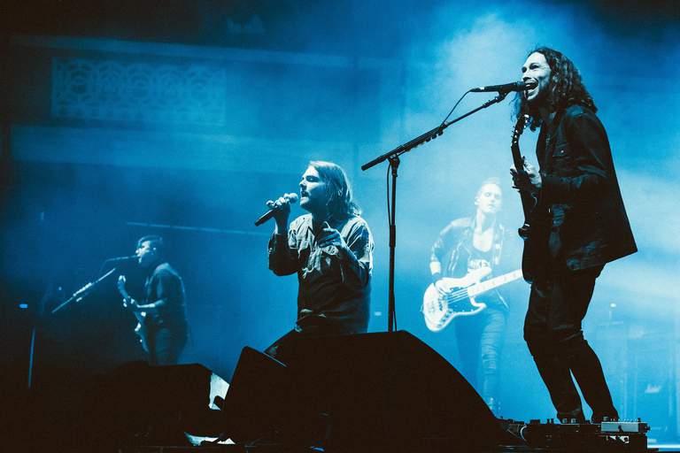 The band My Chemical Romance playing on a stage.