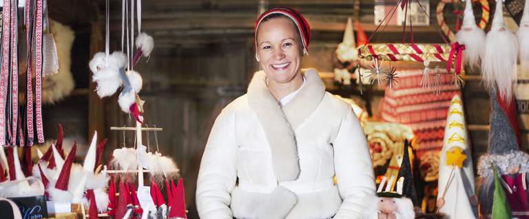 Woman in a market shop with artisan objects.