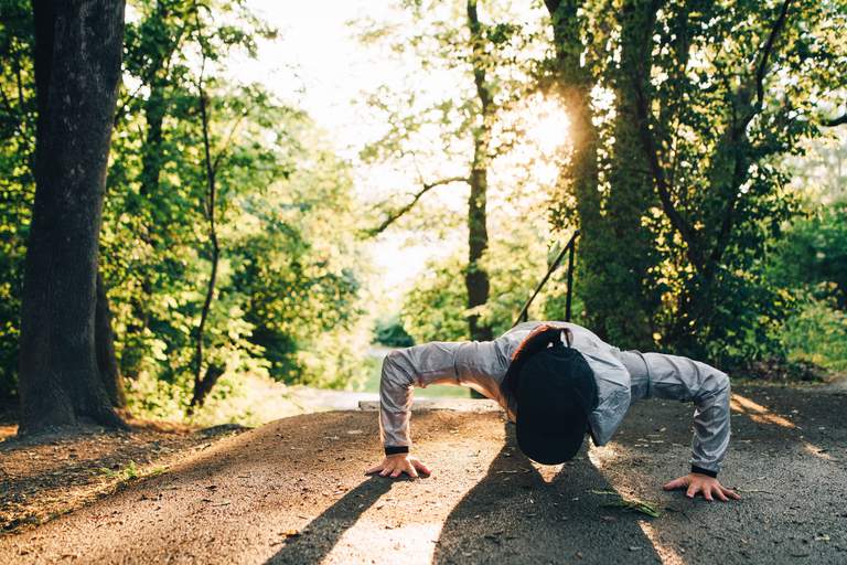 A person doing push-ups outdoors