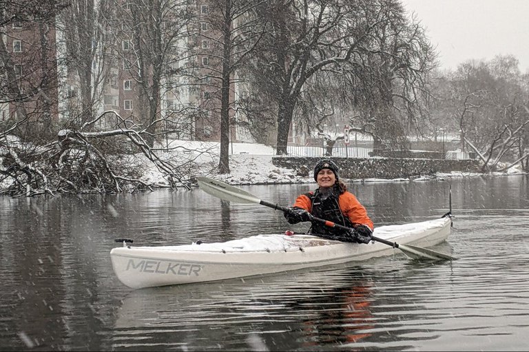 A person in a kayak on a winter day.