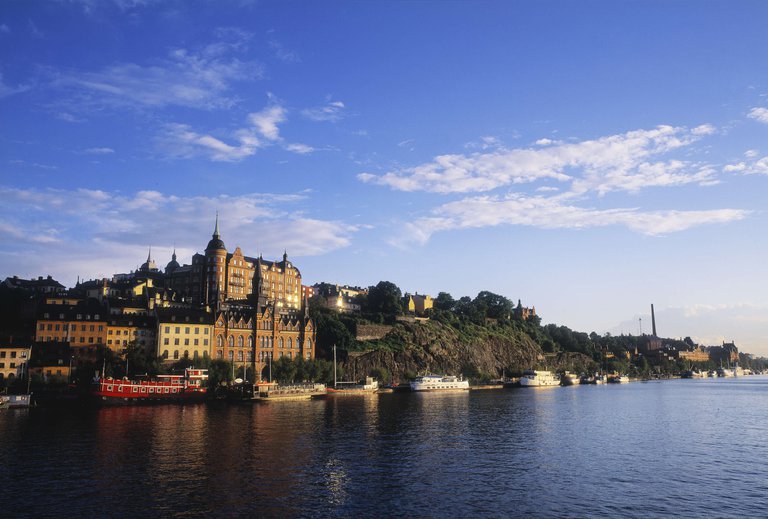 View of boats and buildings on Söder Mälarstrand in Stockholm on a sunny day.