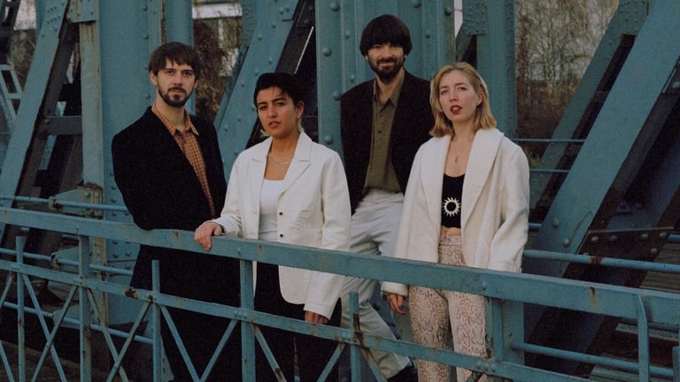 A photo of four musicians.