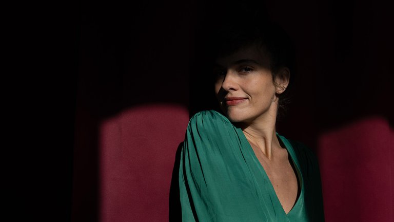 Camille Bertault in green clothes.