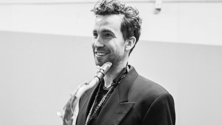 Photo of a musician with his musical instrument.