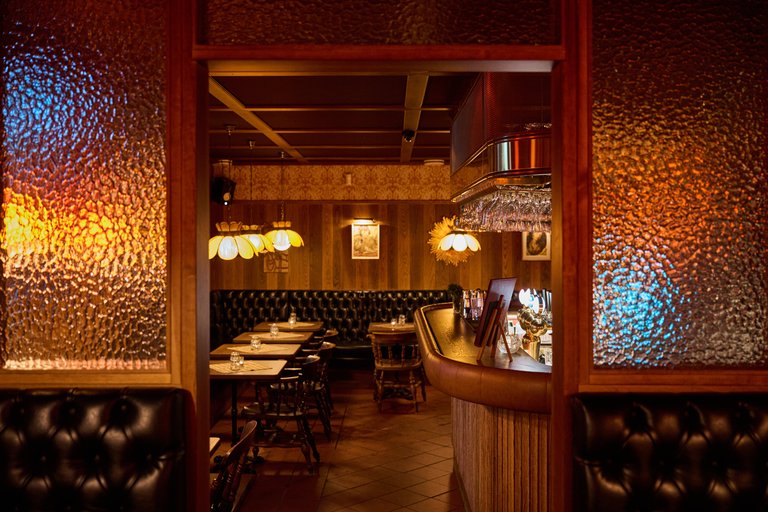 Restaurants in Stockholm. The interior at Rosetta's in Hornstull. Wooden panel line the walls and cozy lightning.