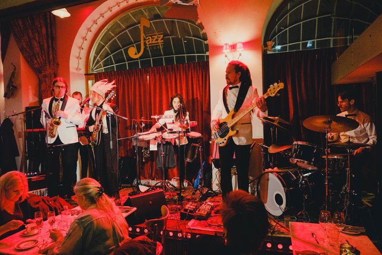 Musicians playing on a stage.