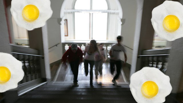 montage: photo of children running up the stairs at the City Museum, with cracked eggs superimposed on the picture