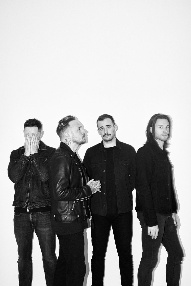 Four men in black jackets.