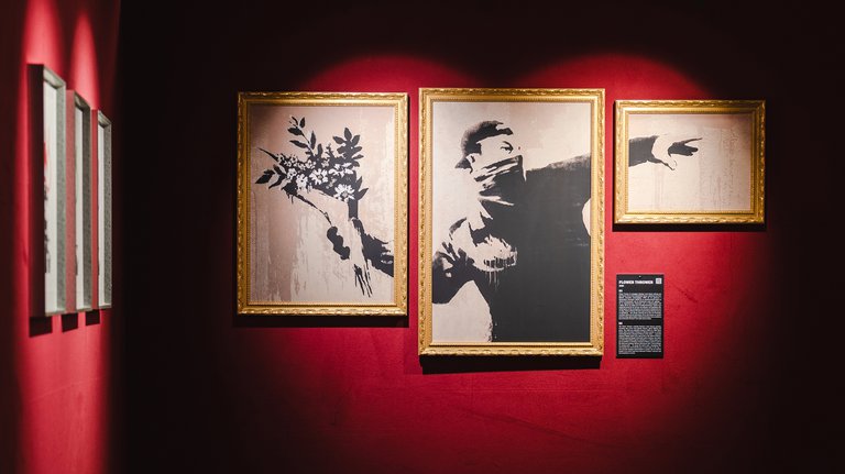 Exhibitions in Stockholm. A framed version of Banksy's iconic stencil mural hanging at Stadsgårdsterminalen.