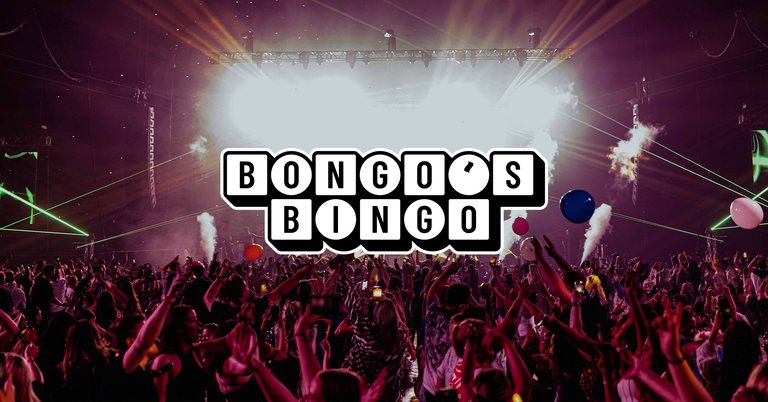 A large crowd at a Bongo's Bingo event with dramatic stage lighting and confetti