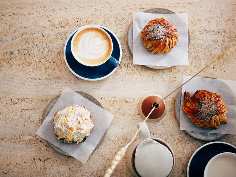 Cafees in Stockhoilm. A table set for fika at Café Pascal on Södermalm. Coffe and two cinnamon buns.