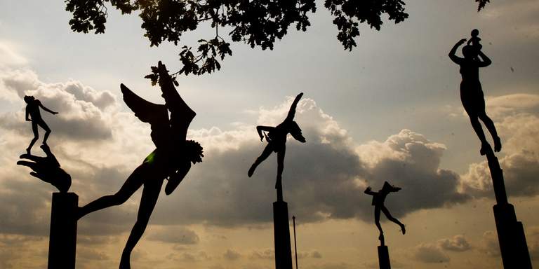 The sculpture park at the beautiful art museum Millesgården, huge sculptures of humans and angels by the sculptor Carl Milles against the evening sky.