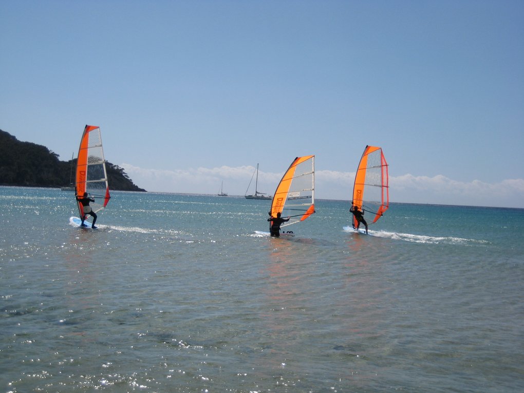 three surfers