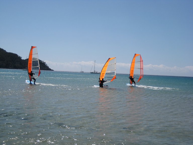 three surfers