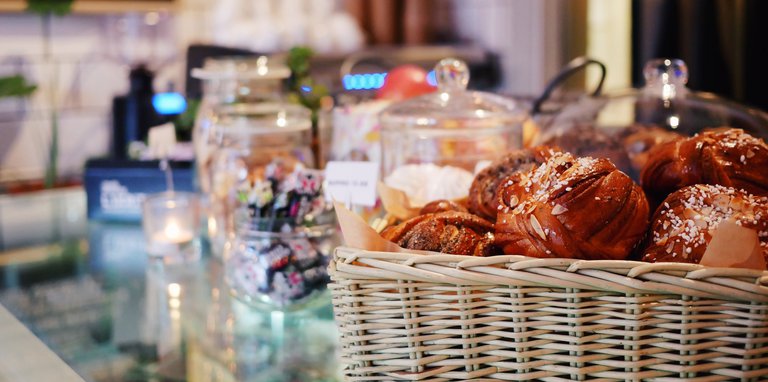 Fika in Stockholm. A basket of cinnamon buns at a counter.
