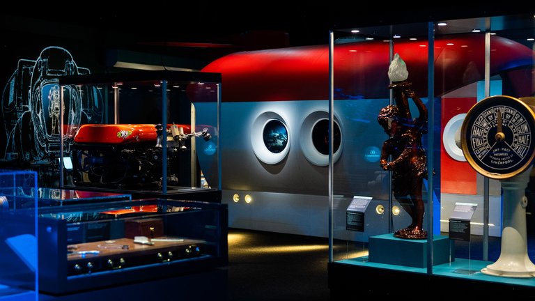 Museum exhibit with diving suit, submersible.