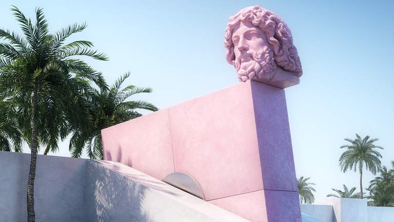 A sculpture of the head of Zeus on the edge of a wall with several palm trees nearby.