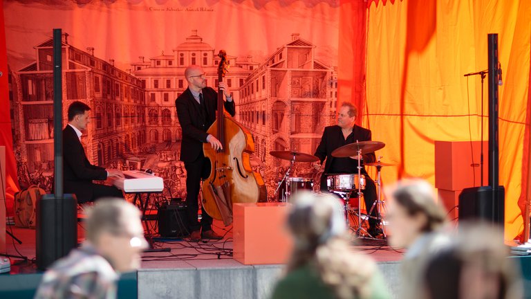 A orchestra playing on a stage.