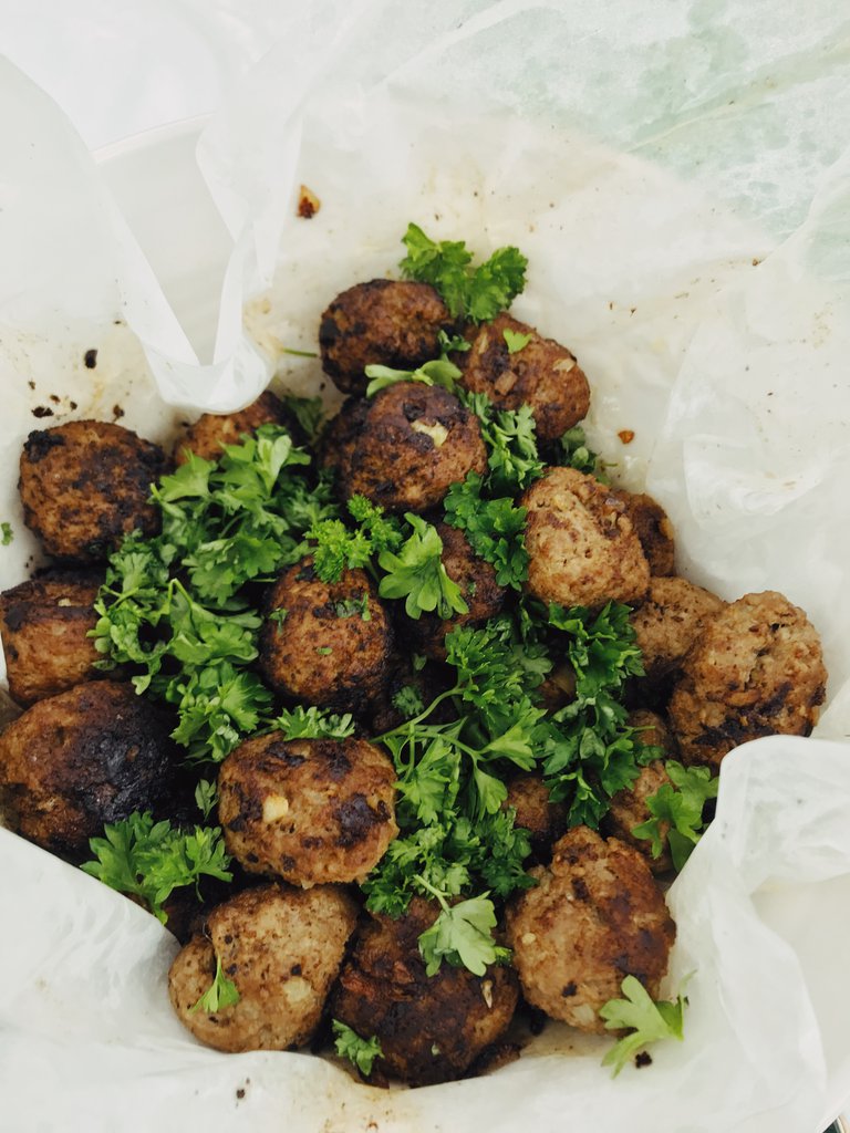 Swedish food. A bowl of meat balls, sprinkled with parsley.