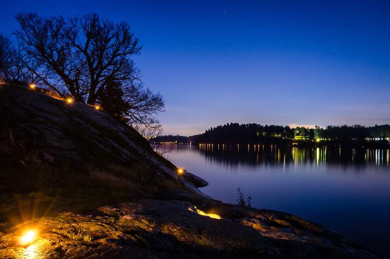 An illuminated shore at night.